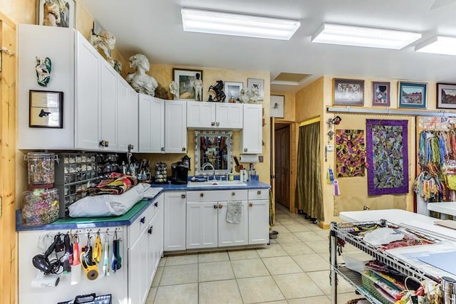 134 E Virginia Ave, La Veta, CO 81055 - kitchen featuring white cabinetry, a sink, and light tile patterned flooring