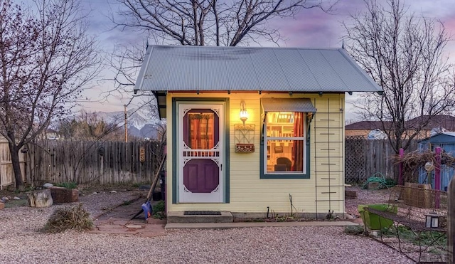 134 E Virginia Ave, La Veta, CO 81055 - outdoor structure at dusk featuring a fenced backyard and an outbuilding
