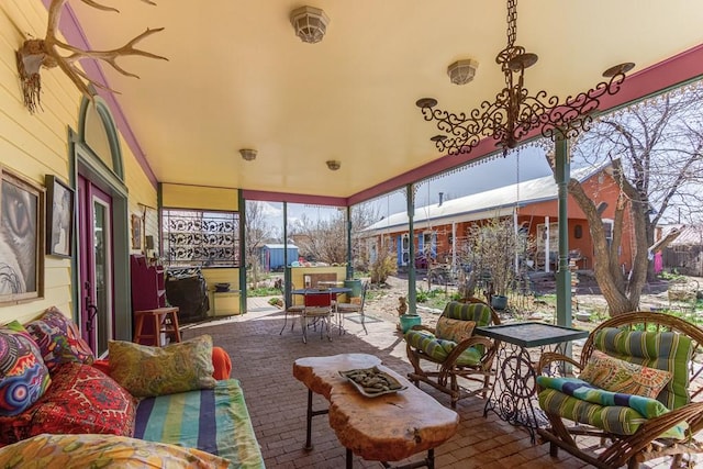 134 E Virginia St, La Veta, CO 81055 - sunroom / solarium featuring outdoor dining space, outdoor lounge area, and brick patterned flooring