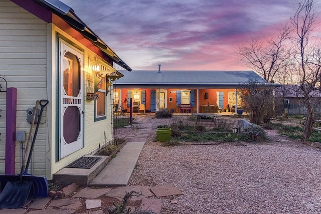134 E Virginia Ave, La Veta, CO 81055 - back of house at dusk featuring a porch