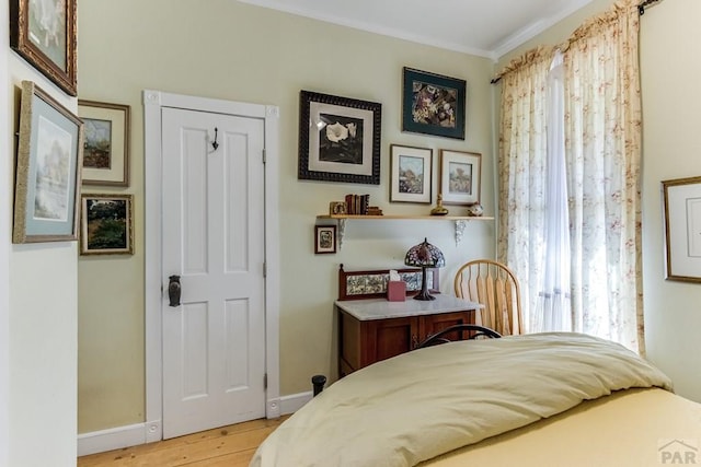134 E Virginia Ave, La Veta, CO 81055 - bedroom with baseboards, multiple windows, ornamental molding, and wood finished floors