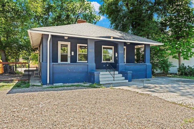 832 Berkley Ave Unit 834, Pueblo, CO 81004 - bungalow-style home featuring a porch, a chimney, stucco siding, and a shingled roof