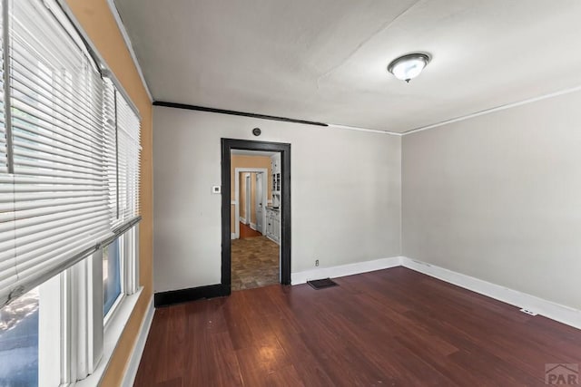 832 Berkley Ave Unit 834, Pueblo, CO 81004 - unfurnished room featuring ornamental molding and dark wood-type flooring