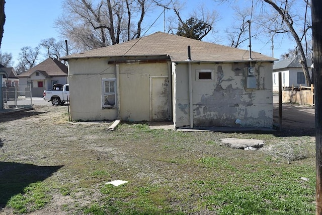 back of property featuring fence