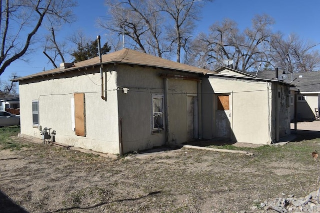 view of side of home featuring stucco siding