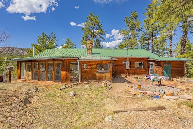 8929 Apache Dr, Beulah, CO 81023 - back of house featuring a chimney and metal roof