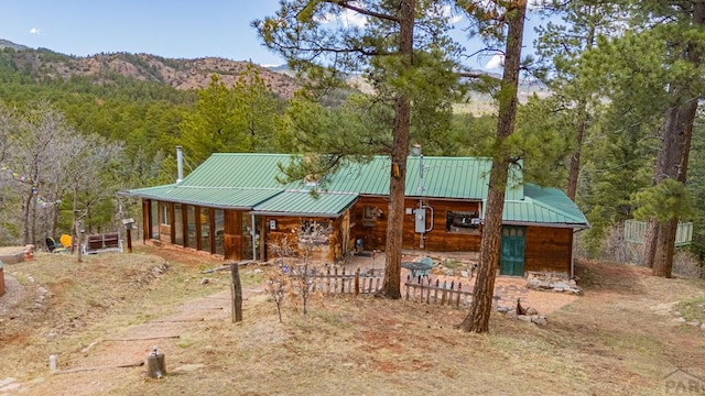 8929 Apache Dr, Beulah, CO 81023 - view of front of home with a porch, a wooded view, metal roof, and a mountain view