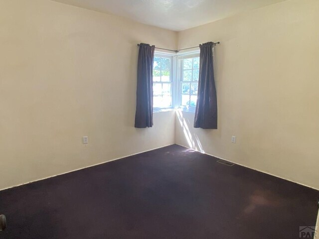 empty room with carpet and visible vents