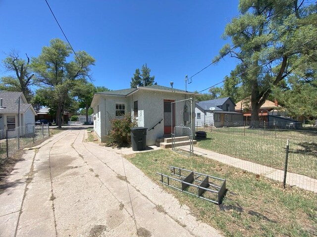 view of front of house featuring fence and stucco siding