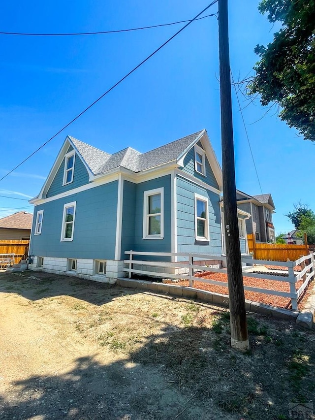 15 E 8th St, La Junta, CO 81050 - view of side of property with a shingled roof