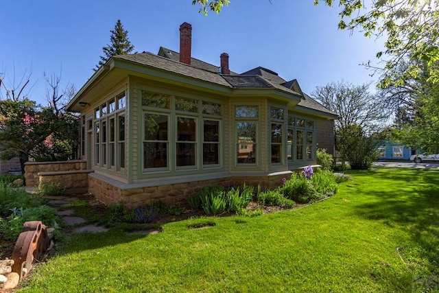 314 S Main St, La Veta, CO 81055 - back of house featuring a sunroom, a chimney, and a yard
