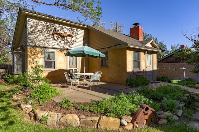 314 S Main St, La Veta, CO 81055 - back of property with a chimney and a patio