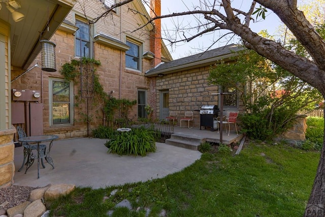 314 S Main St, La Veta, CO 81055 - rear view of property featuring a yard, stone siding, and a patio