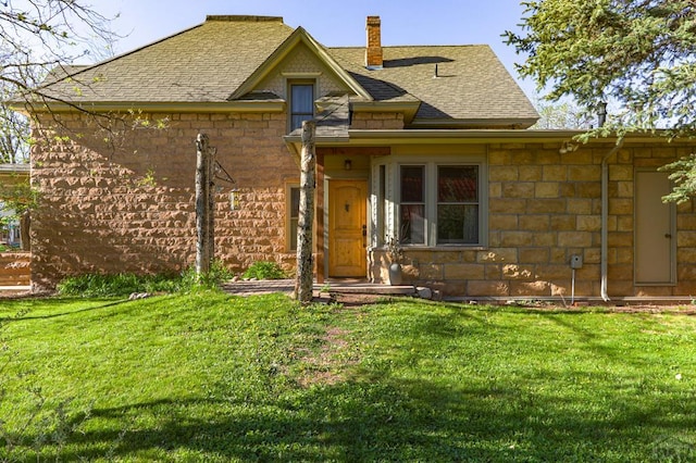 314 S Main St, La Veta, CO 81055 - view of front of house featuring stone siding, a shingled roof, a chimney, and a front yard