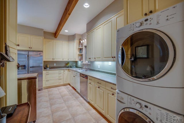 314 S Main St, La Veta, CO 81055 - kitchen with stainless steel appliances, a sink, stacked washer / drying machine, light countertops, and beam ceiling