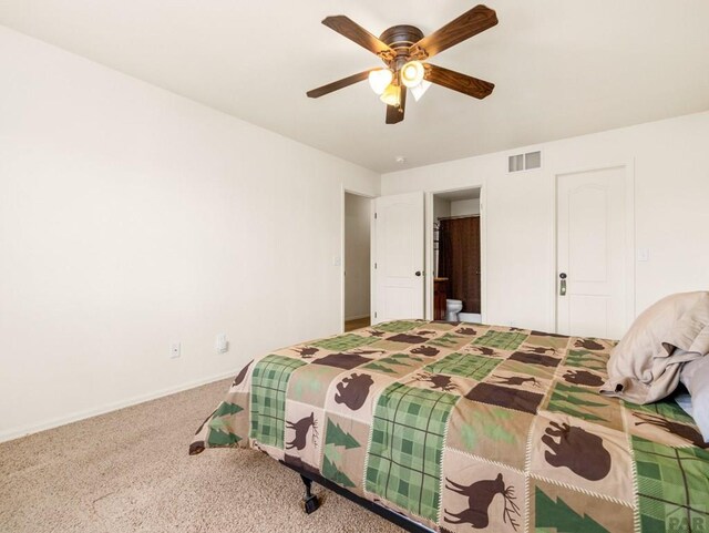 bedroom featuring visible vents, connected bathroom, baseboards, carpet flooring, and ceiling fan