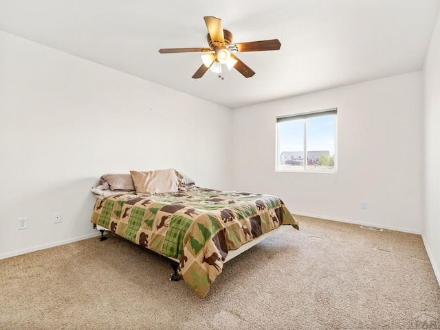 bedroom with visible vents, baseboards, carpet flooring, and ceiling fan