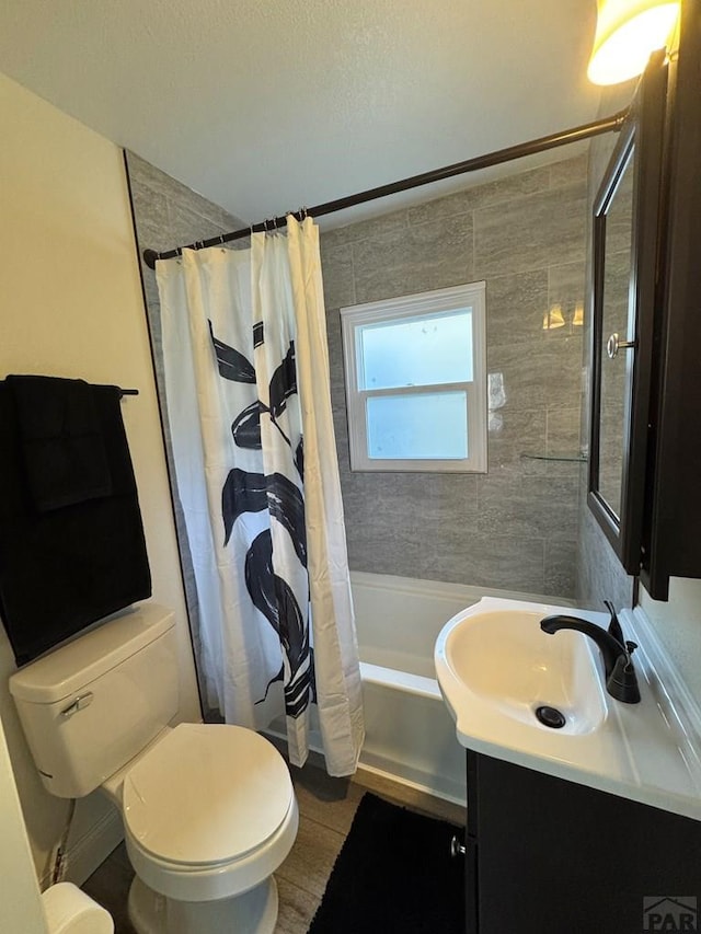 bathroom with toilet, shower / tub combo, and vanity