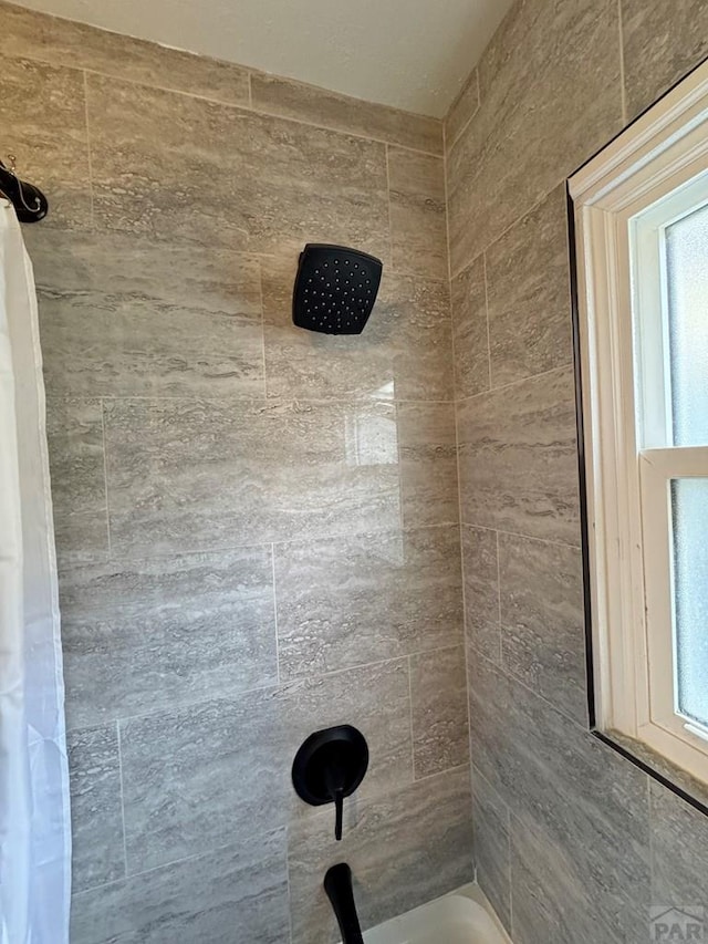 bathroom with tiled shower