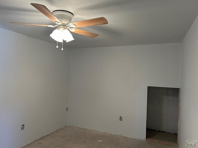 empty room featuring ceiling fan and unfinished concrete flooring