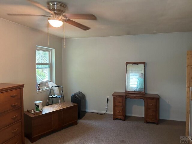 home office featuring light carpet and ceiling fan