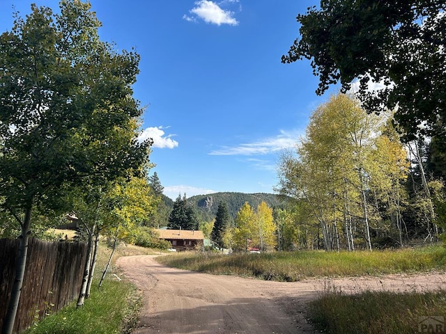 view of road featuring a forest view