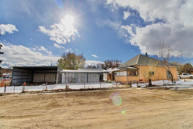 rear view of property featuring fence