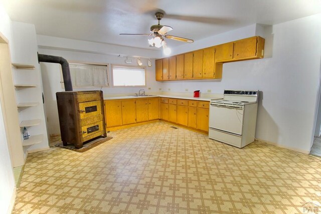 kitchen with white electric stove, light floors, light countertops, a sink, and ceiling fan