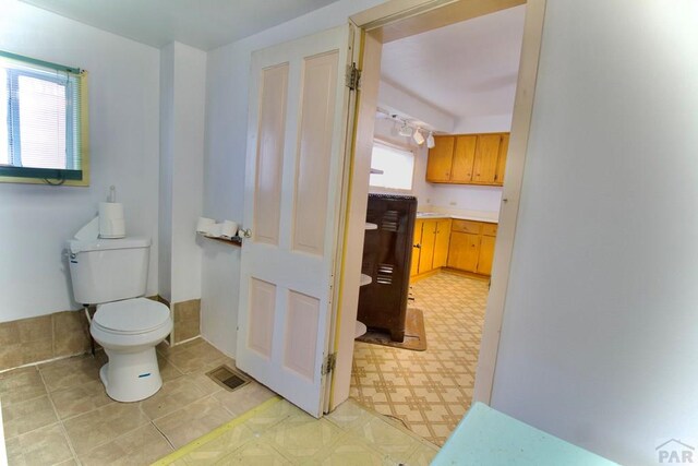 bathroom with visible vents, toilet, and tile patterned floors