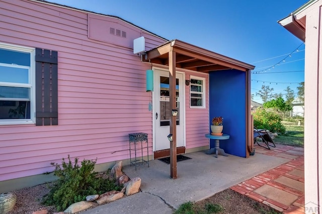 entrance to property with a patio area