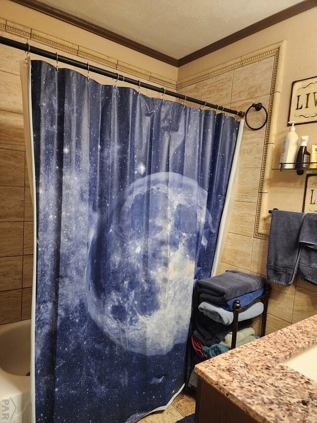 bathroom with ornamental molding, shower / tub combo, and a textured ceiling