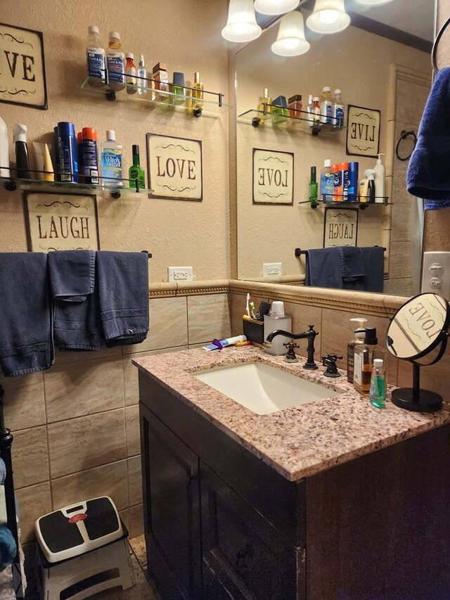 bathroom with tile walls and vanity