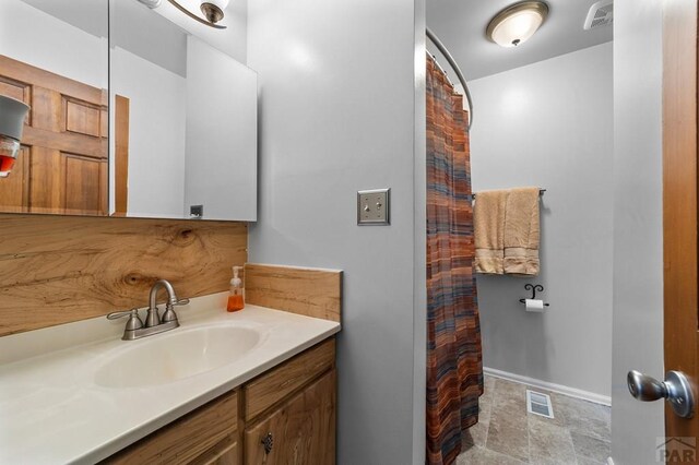 bathroom with visible vents, vanity, and baseboards