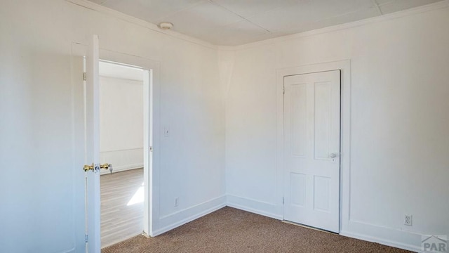 509 Walsen Ave, Walsenburg, CO 81089 - empty room featuring crown molding, baseboards, and carpet flooring