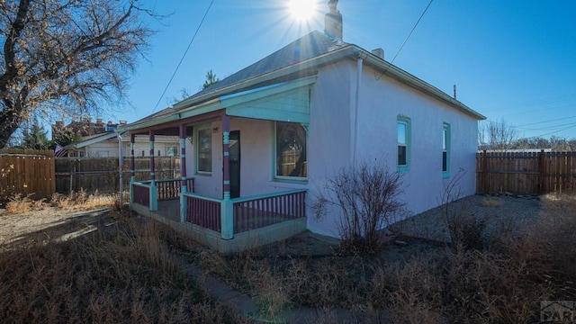 509 Walsen Ave, Walsenburg, CO 81089 - exterior space with a porch, a fenced backyard, and stucco siding