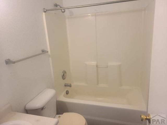 bathroom featuring shower / bath combination, vanity, and toilet