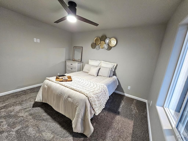 bedroom with ceiling fan, dark carpet, and baseboards