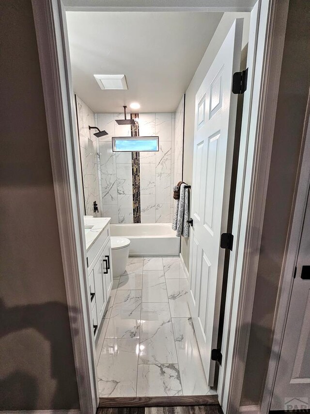 bathroom with marble finish floor, visible vents, toilet, a combined bath / shower with rainfall shower, and vanity