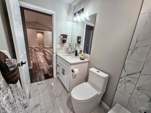 bathroom with marble finish floor, vanity, toilet, and baseboards