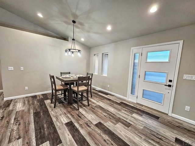 dining area with baseboards, vaulted ceiling, and dark wood-type flooring