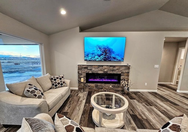 living room featuring baseboards, vaulted ceiling, and wood finished floors