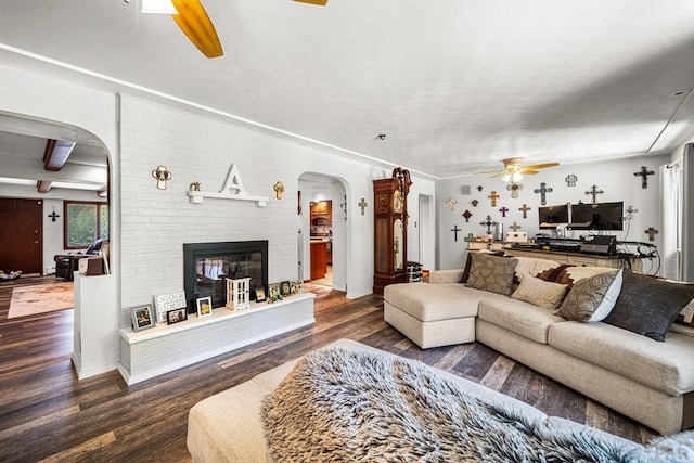67 Macarthur Rd, Pueblo, CO 81001 - living area featuring ceiling fan, arched walkways, wood finished floors, and a brick fireplace