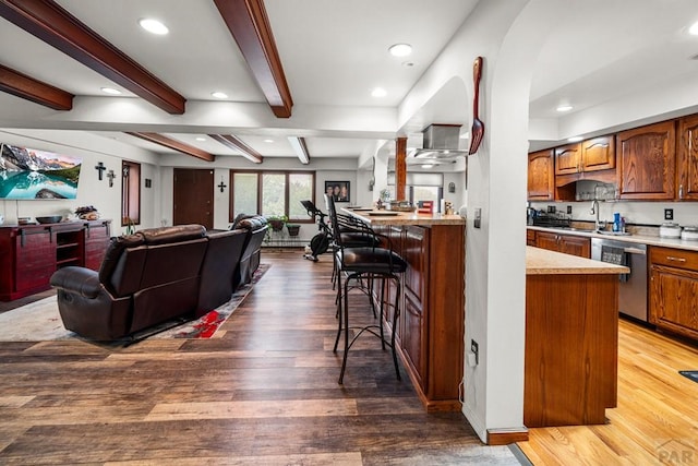 67 Macarthur Rd, Pueblo, CO 81001 - living room featuring wood finished floors, beamed ceiling, recessed lighting, and arched walkways