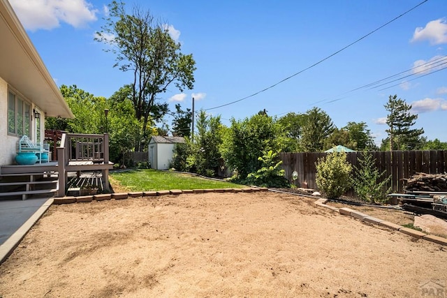 67 Macarthur Rd, Pueblo, CO 81001 - fenced backyard featuring a shed and a wooden deck