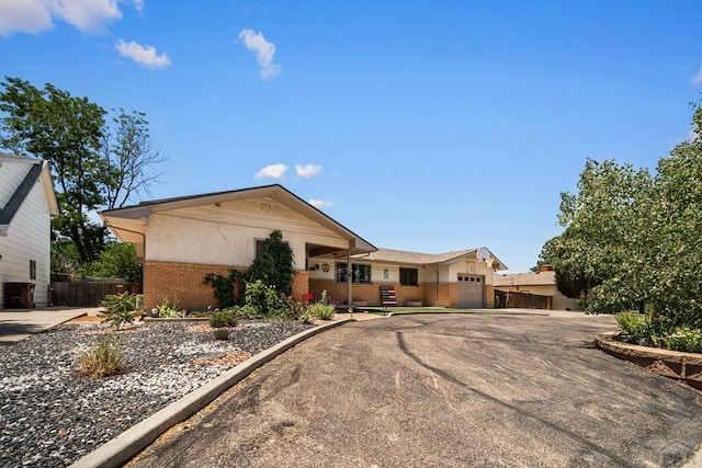 67 Macarthur Rd, Pueblo, CO 81001 - ranch-style house featuring brick siding, a garage, and driveway