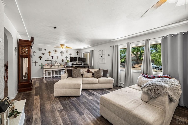 67 Macarthur Rd, Pueblo, CO 81001 - living area with a ceiling fan, dark wood-style flooring, and arched walkways