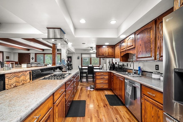 67 Macarthur Rd, Pueblo, CO 81001 - kitchen featuring appliances with stainless steel finishes, light wood finished floors, a ceiling fan, island exhaust hood, and recessed lighting