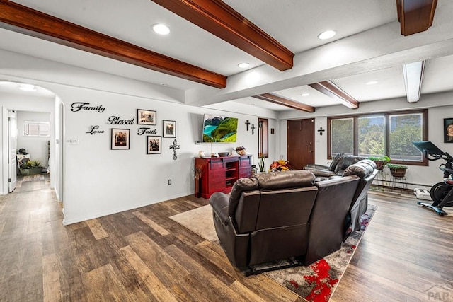 67 Macarthur Rd, Pueblo, CO 81001 - living room featuring arched walkways, wood finished floors, beam ceiling, recessed lighting, and a baseboard radiator