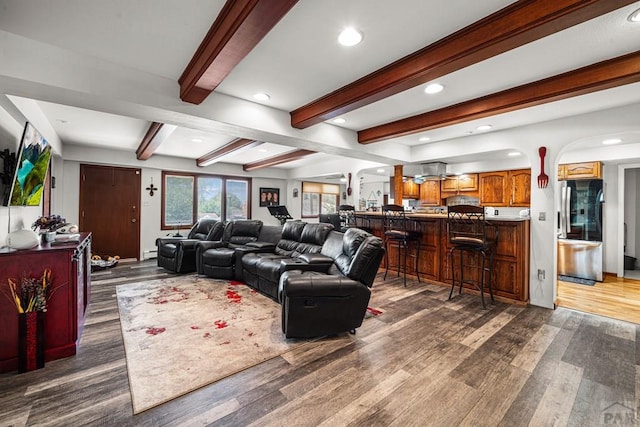 67 Macarthur Rd, Pueblo, CO 81001 - living area featuring wood finished floors, arched walkways, recessed lighting, and beamed ceiling