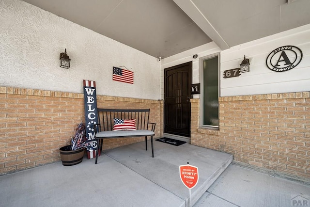 67 Macarthur Rd, Pueblo, CO 81001 - view of exterior entry featuring brick siding and covered porch